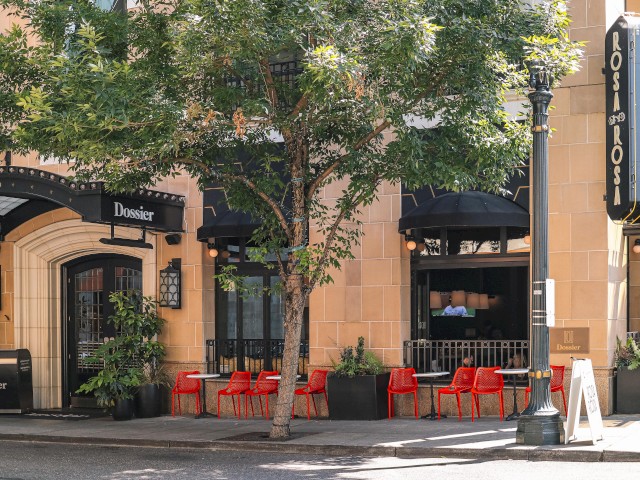 The image shows a sidewalk view of a building housing 